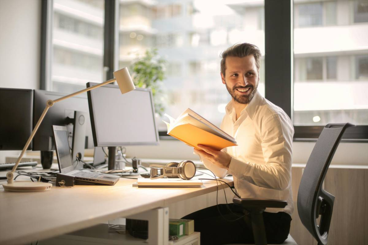 Man looking away from his documents, smiling