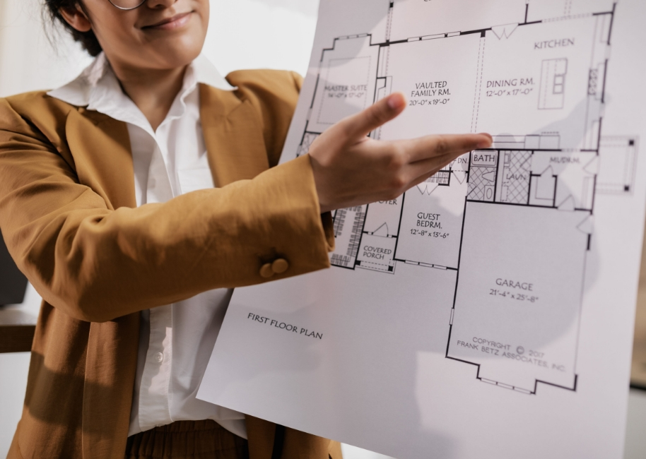 A realtor presenting a blueprint