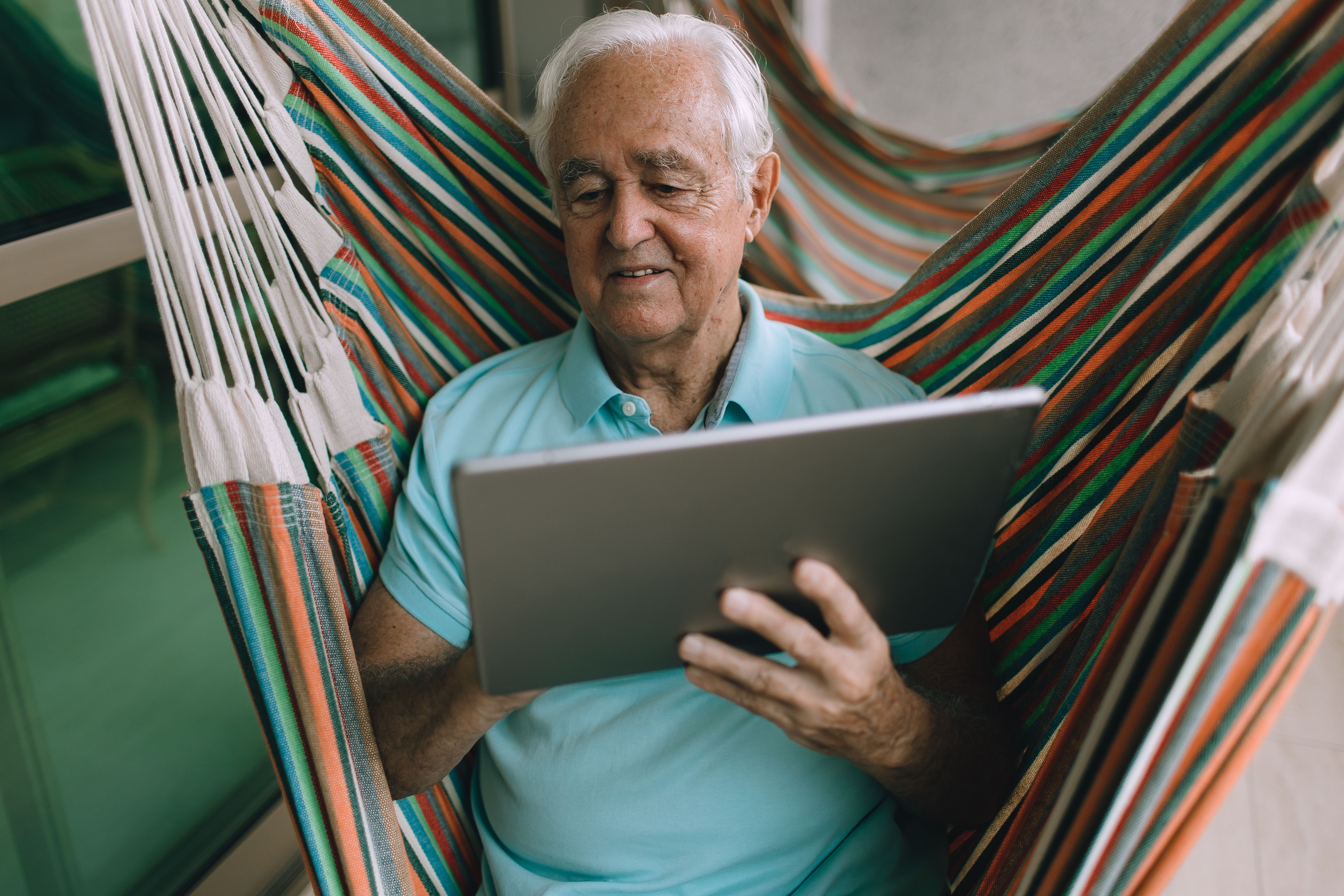 A retired gentleman using his tablet