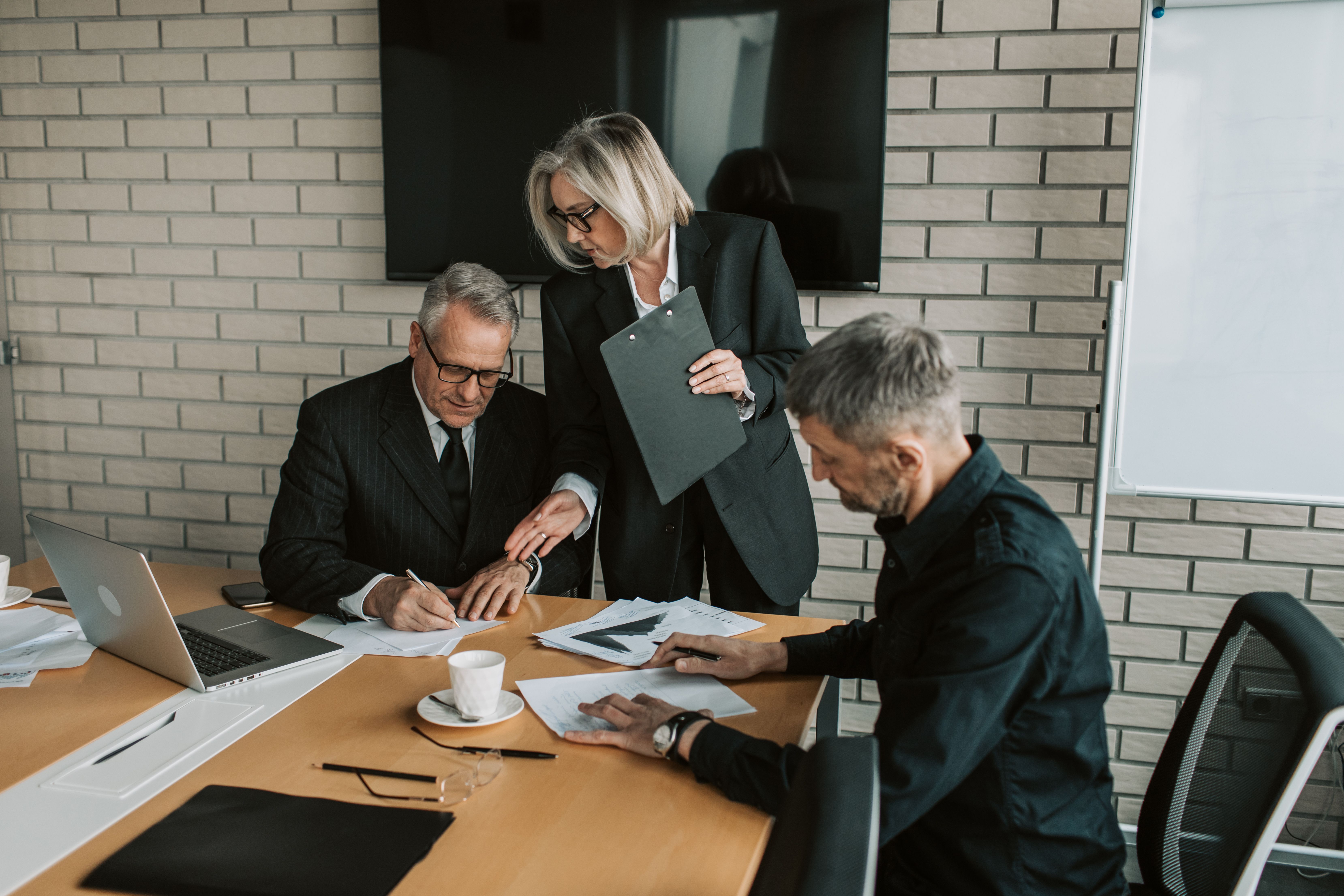 Three business professionals in a conference room
