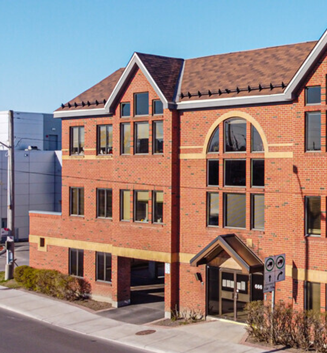 A red brick building at the corner of a street